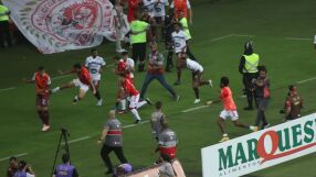 Агресия: Фен с дете на ръце рита футболист между краката (ВИДЕО)